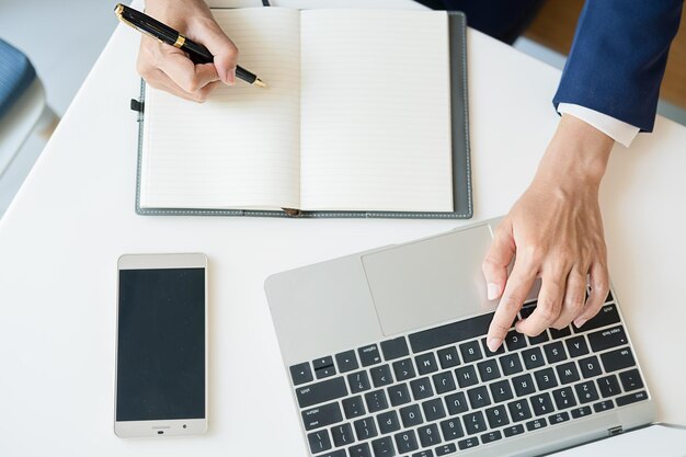 midsection of man using laptop on table