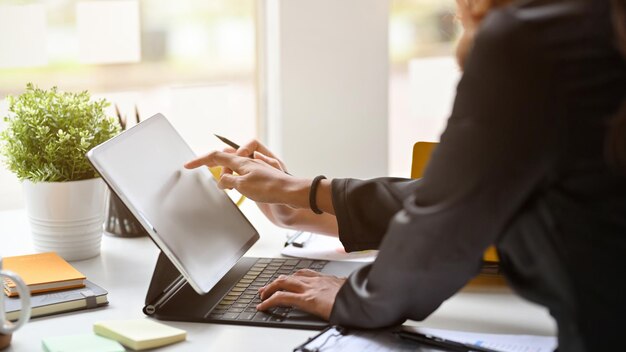 Midsection of man using laptop on table