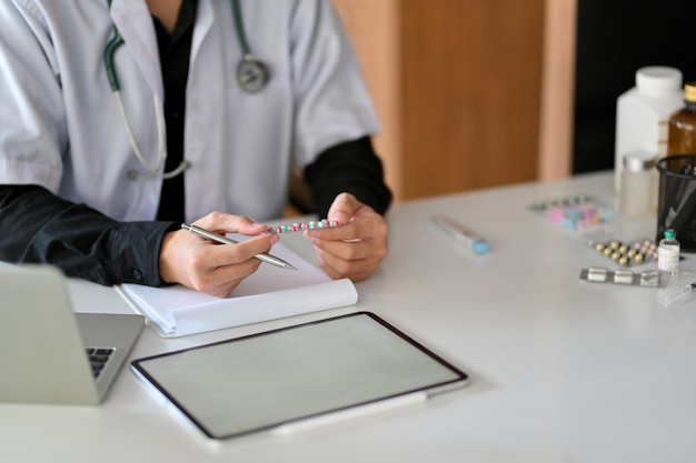 Midsection of man using laptop on table