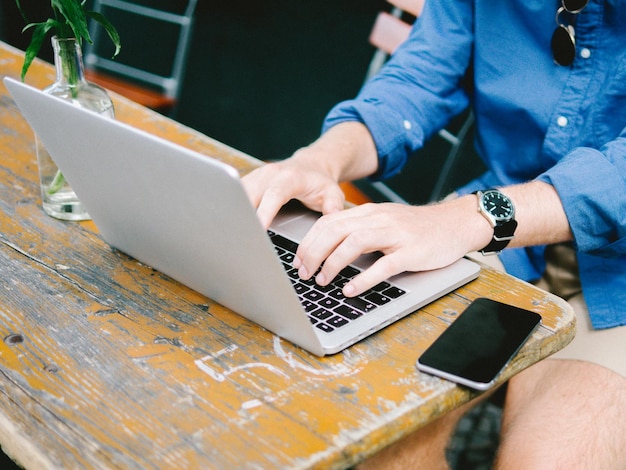 midsection of man using laptop on table
