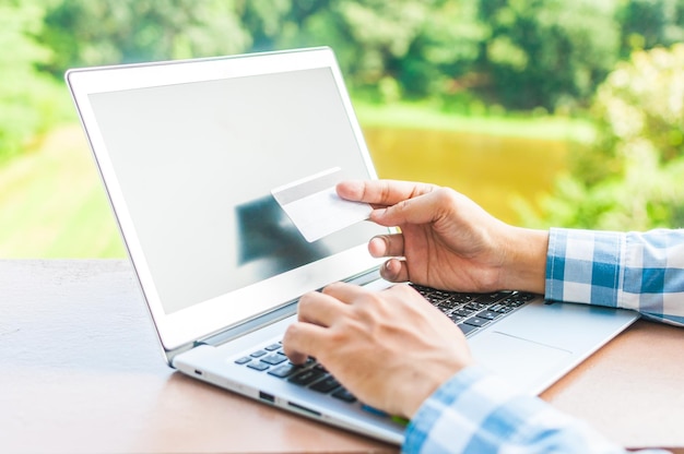 Midsection of man using mobile phone on table