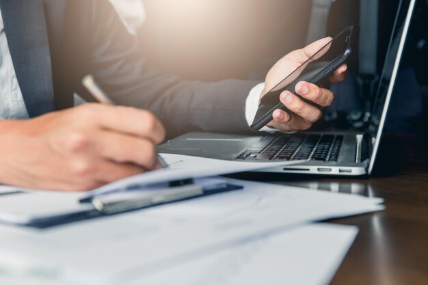 Midsection of man using mobile phone