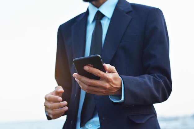 Midsection of man using mobile phone