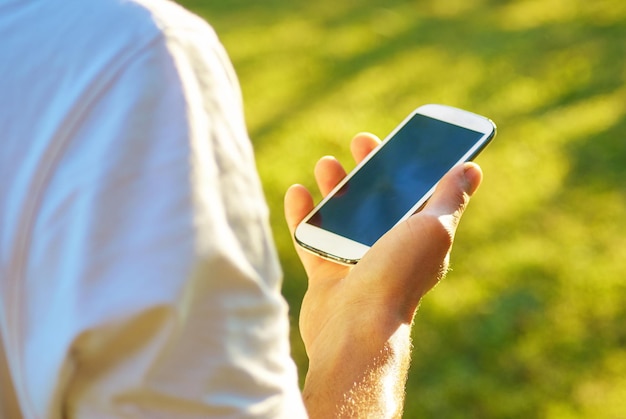midsection of man using mobile phone