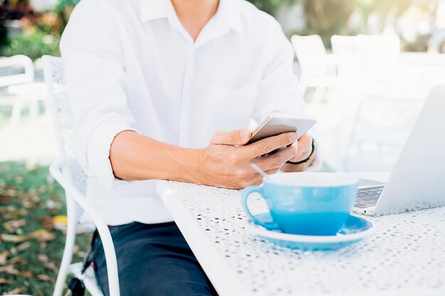 Photo midsection of man using mobile phone