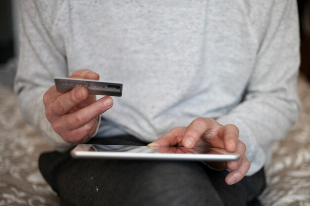 Midsection of man using mobile phone