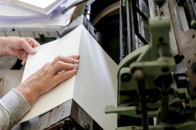 Midsection of man using printing press machine