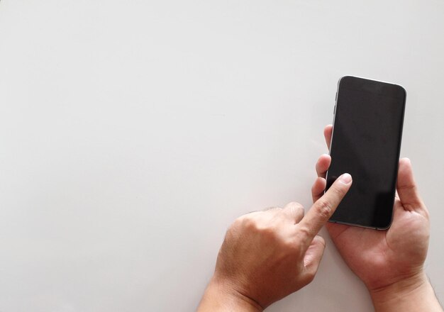 Photo midsection of man using smart phone against white background