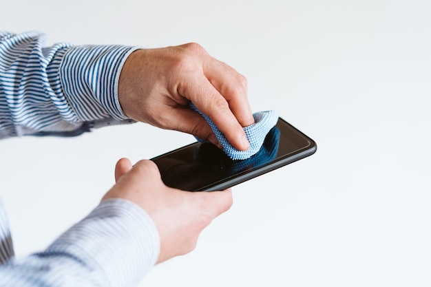 midsection of man using smart phone against white background