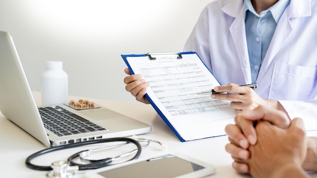 Midsection of man using smart phone on table