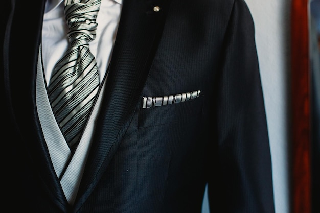 Midsection of man wearing suit