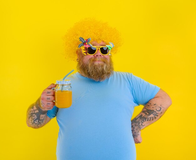 Midsection of man wearing sunglasses standing against yellow background