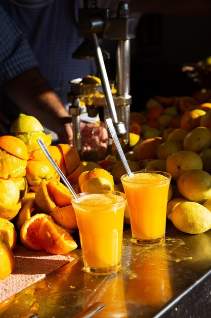 Photo midsection of man with fruits in glass on table