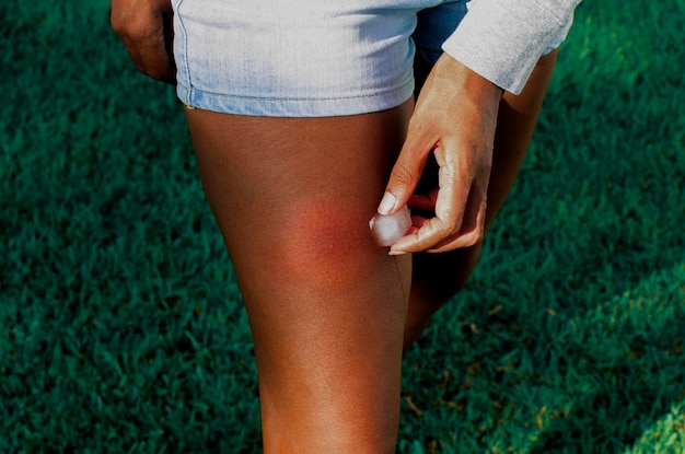 Midsection of man with hand on grass