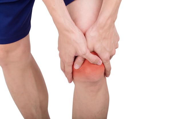 Midsection of man with knee pain against white background