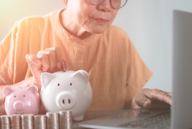 Midsection of man with piggy bank