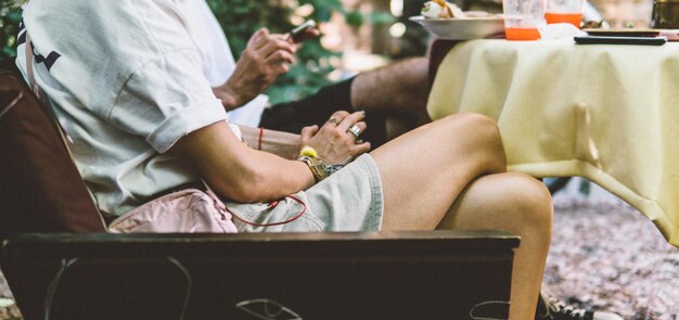 Midsection of man and woman sitting on table