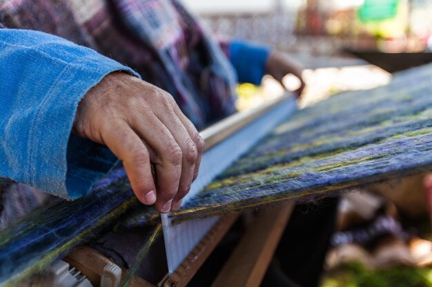 Midsection of man working on wood