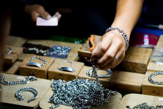 Photo midsection of men making bracelet