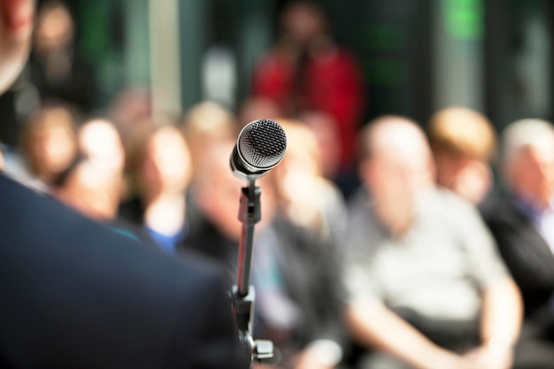 Photo midsection of microphone against crowd