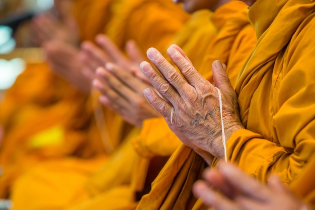 Midsection of monks praying