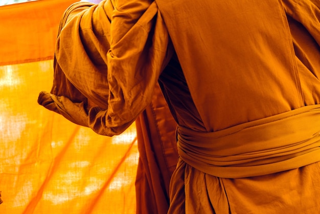 Photo midsection of monks wearing traditional clothing while standing outdoors