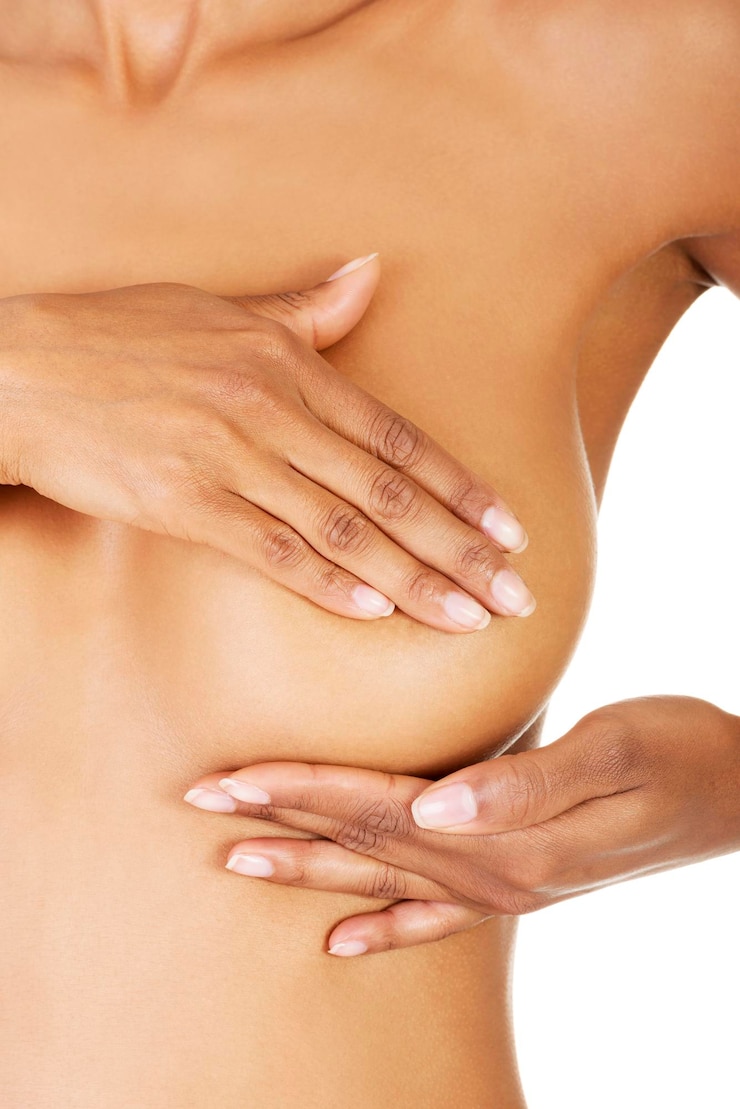 Photo midsection of naked woman standing against white background