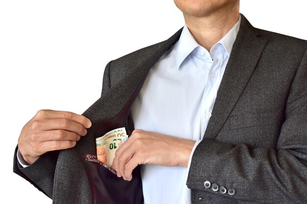 写真 白い背景に紙幣をポケットに入れるビジネスマンのミッドセクション
