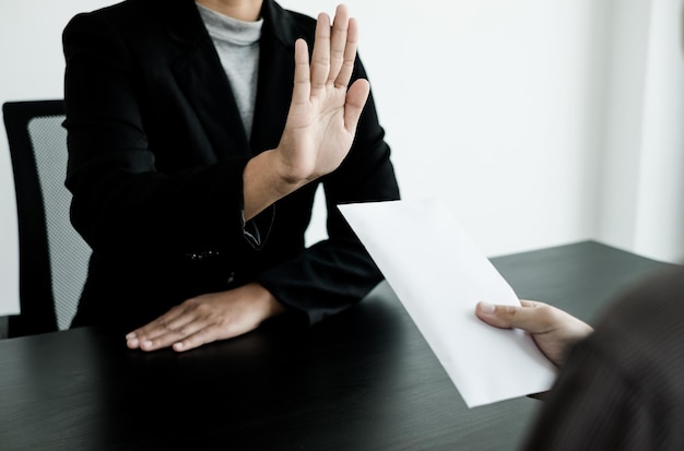 写真 テーブルに座っている男性が紙を握っている中間部分