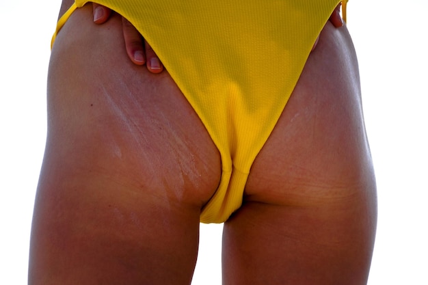 Фото Средняя часть женщины в желтом бикини.