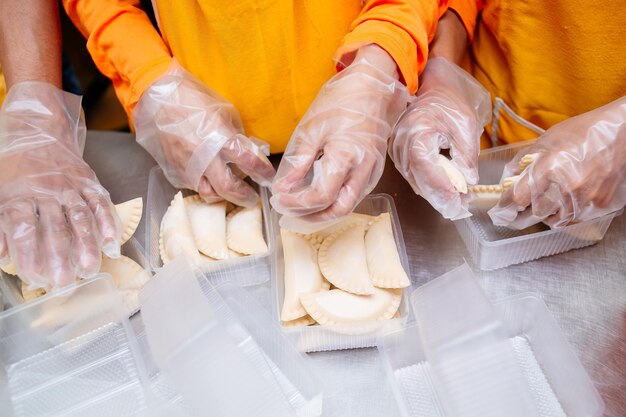 Midsection of people preparing food on table