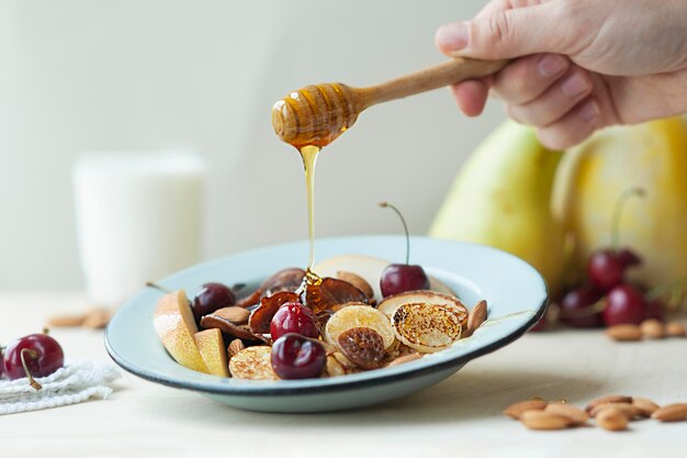 Midsection of person having breakfast on table