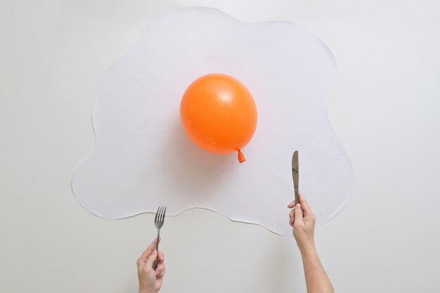 Photo midsection of person holding balloons against white background