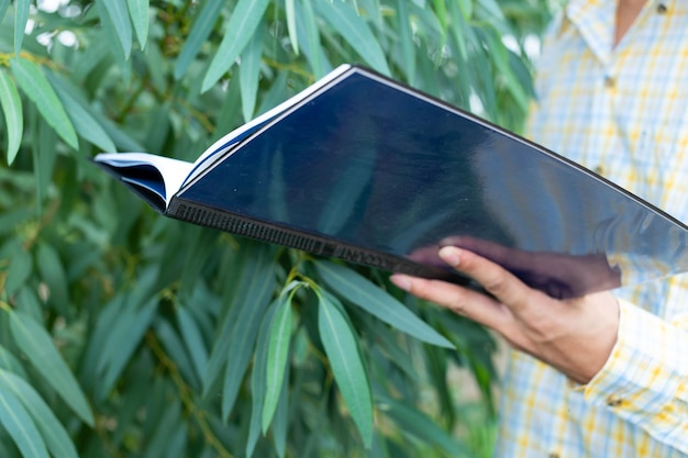 Photo midsection of person holding book