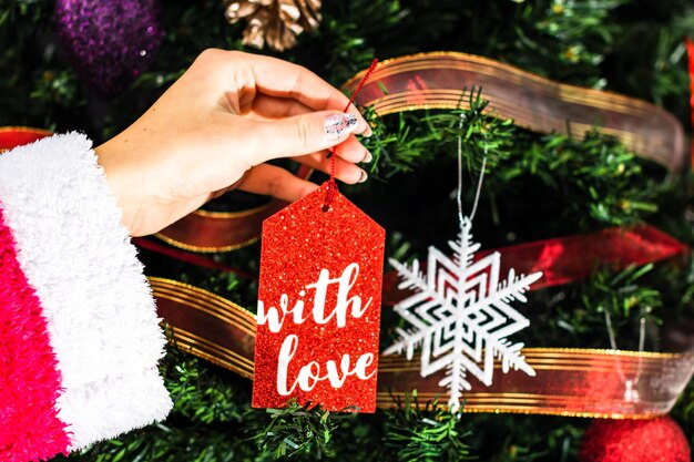 Photo midsection of person holding christmas decoration