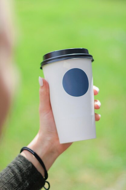Photo midsection of person holding coffee cup