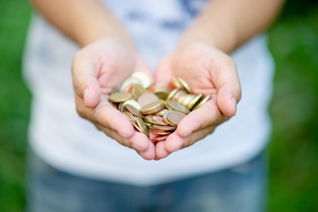 Midsection of person holding coins