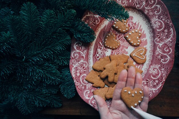 Midsection of person holding cookies on table