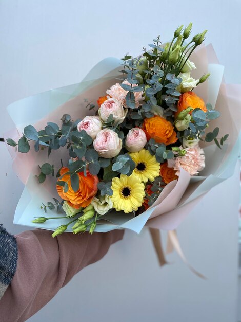 Midsection of person holding flower bouquet