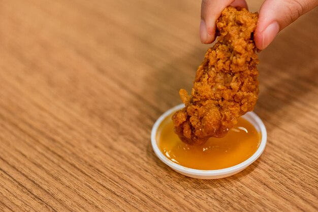 Midsection of person holding food on table