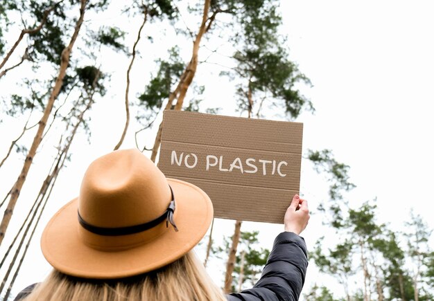 Photo midsection of person holding hat against trees