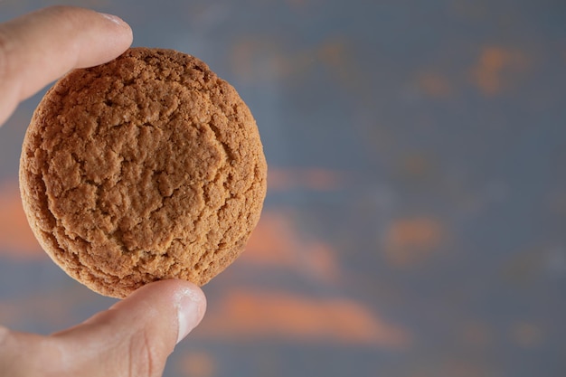 Midsection of person holding ice cream against blurred background