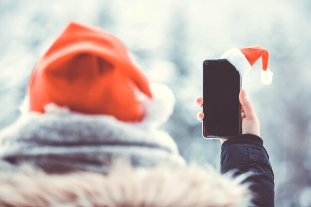 Photo midsection of person holding mobile phone during winter