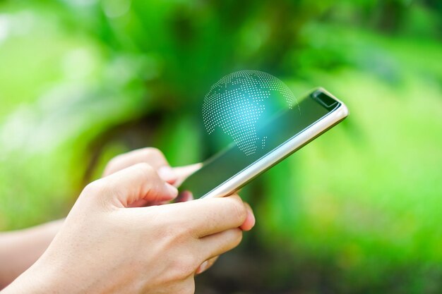 Foto sezione centrale di una persona che tiene un telefono cellulare all'aperto