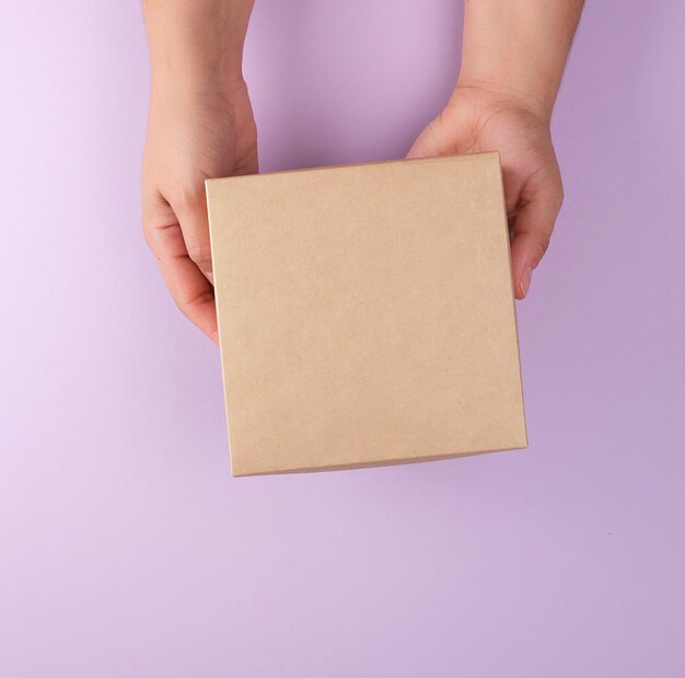 Midsection of person holding paper against white background