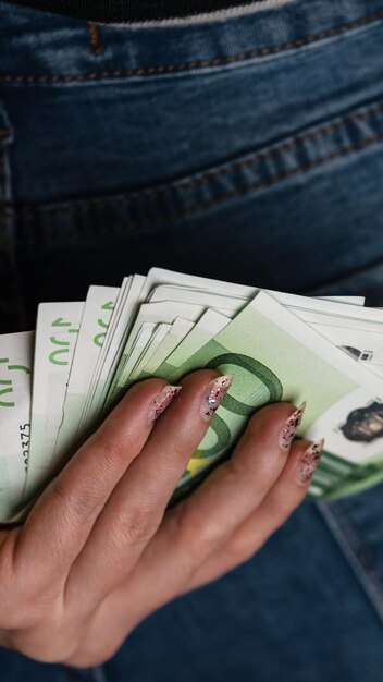 Photo midsection of person holding paper currency