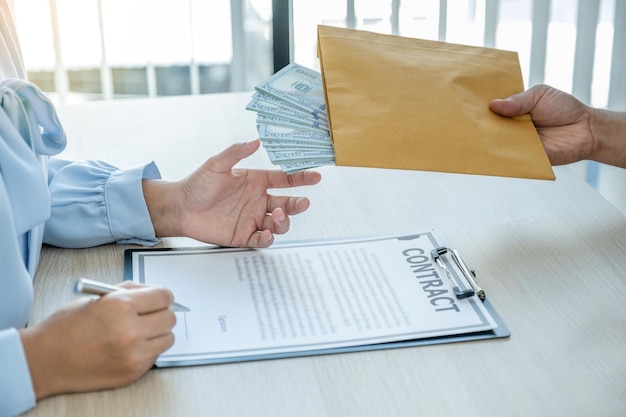 Midsection of person holding paper with text on table