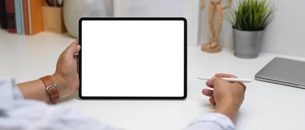 Midsection of person holding smart phone on table