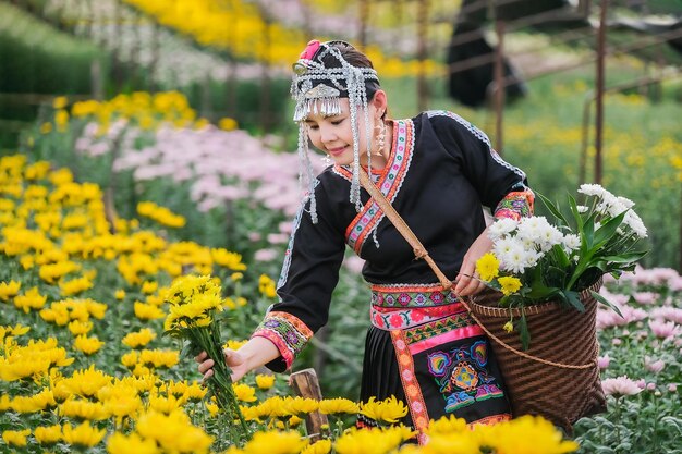 Midsection of person holding yellow flowering plants