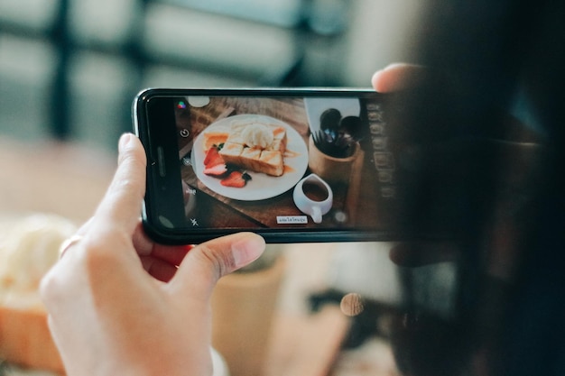 Photo midsection of person photographing with mobile phone